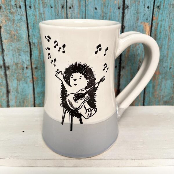 Handmade ceramic mug with drawing of hedgehog playing ukelele