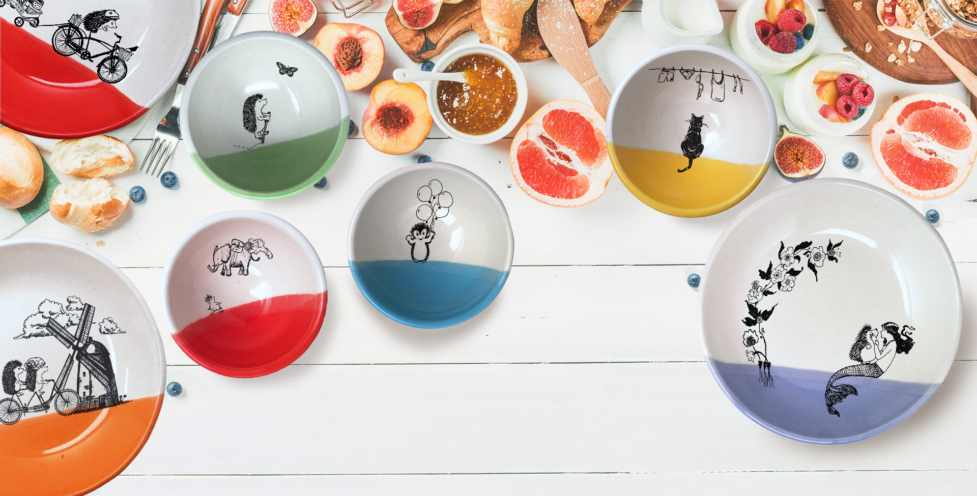 A collection of Darn Pottery's bowls and plates on a colorful table